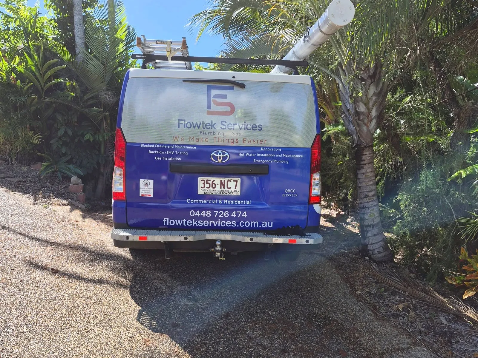 The rear of the Flowtek Services van showing the logo, the services listed, the phone number and the website address