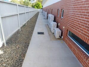 We installed strategically placed drainage pits to capture and redirect surface water away from the building.